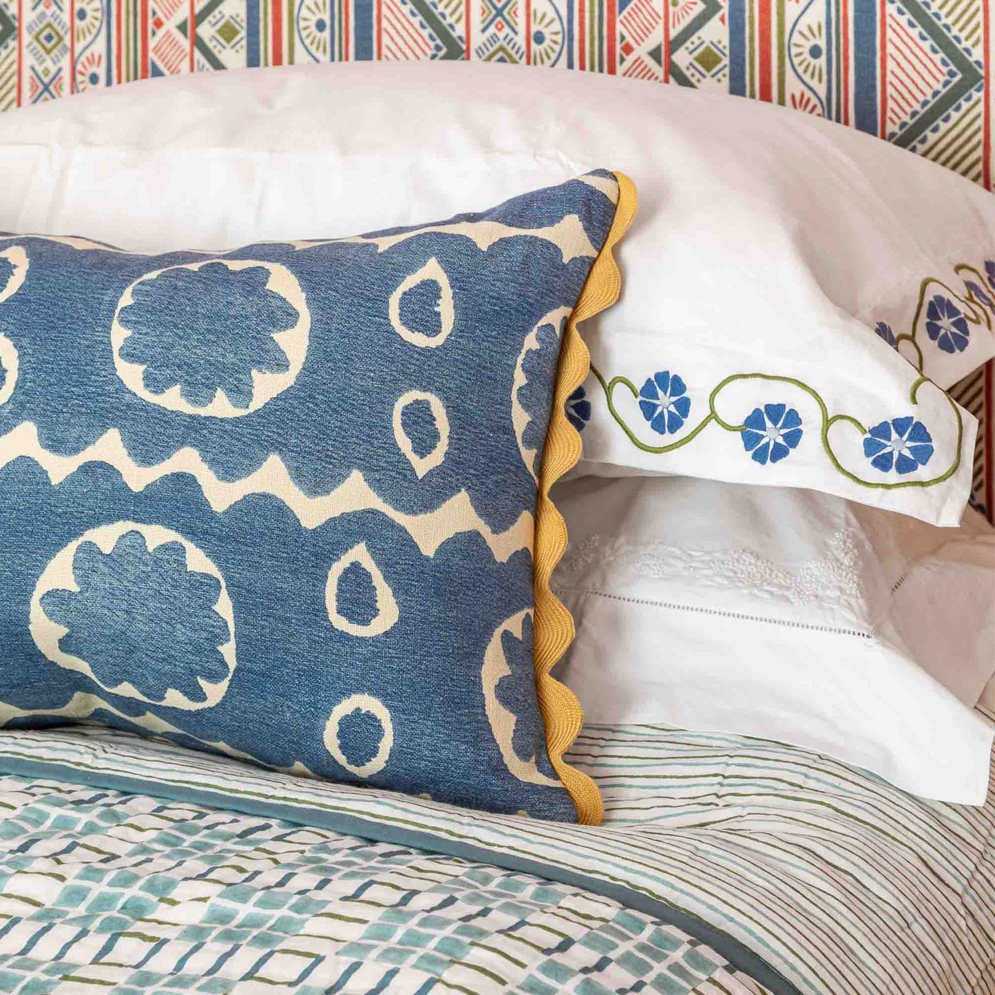 Blue and white floral motif oblong cushion with yellow scallop trim