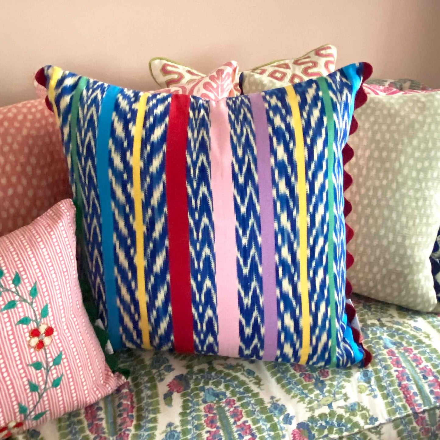 multicoloured cushion with red trim