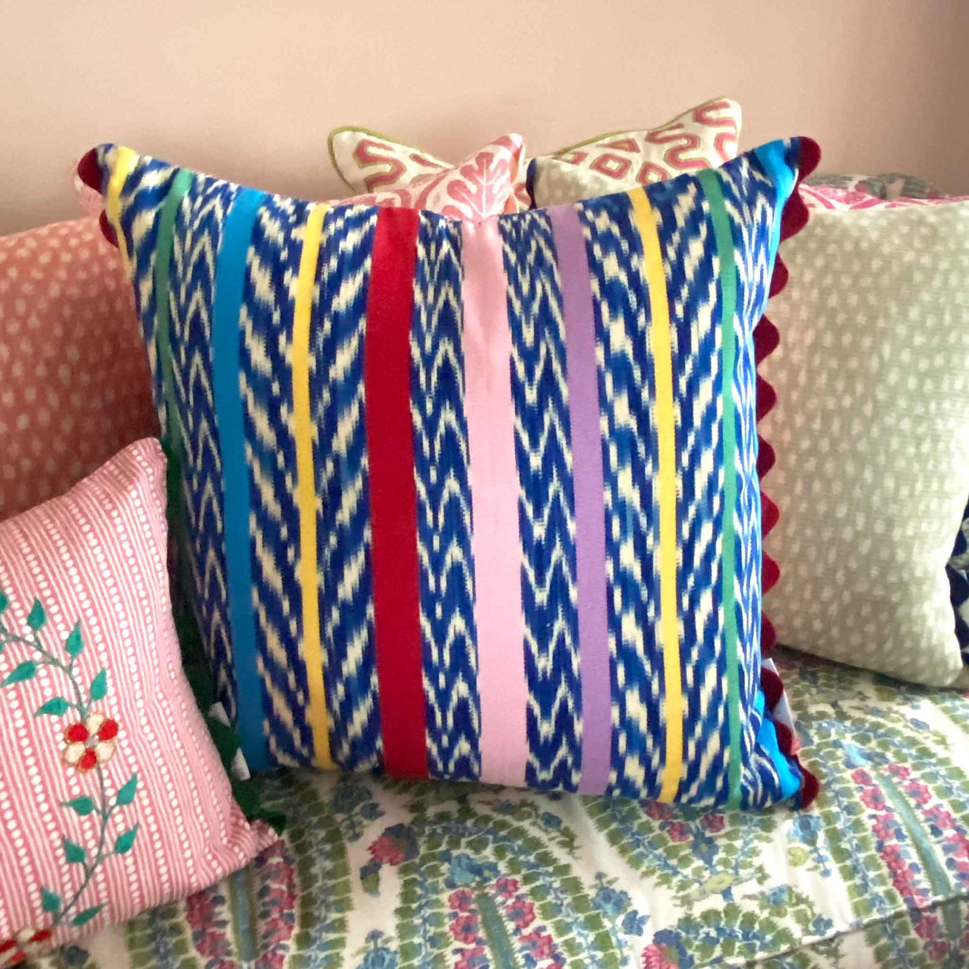 multicoloured cushion with red trim