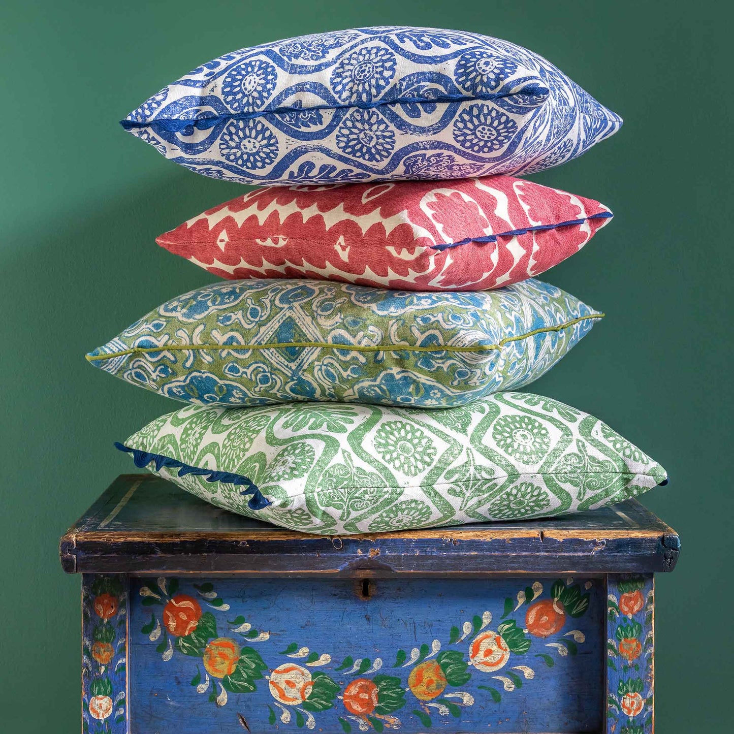 Floral nature blue printed cushion with navy blue scalloped trim.