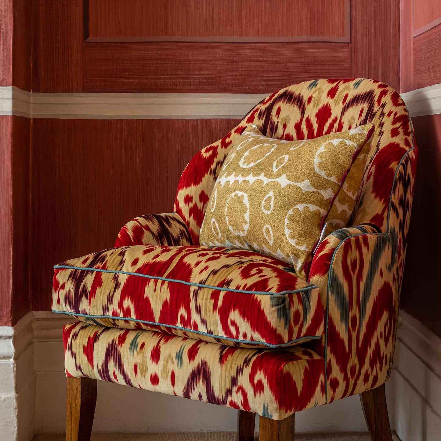 Yellow gold floral oblong fusion with red burgundy scalloped trim.