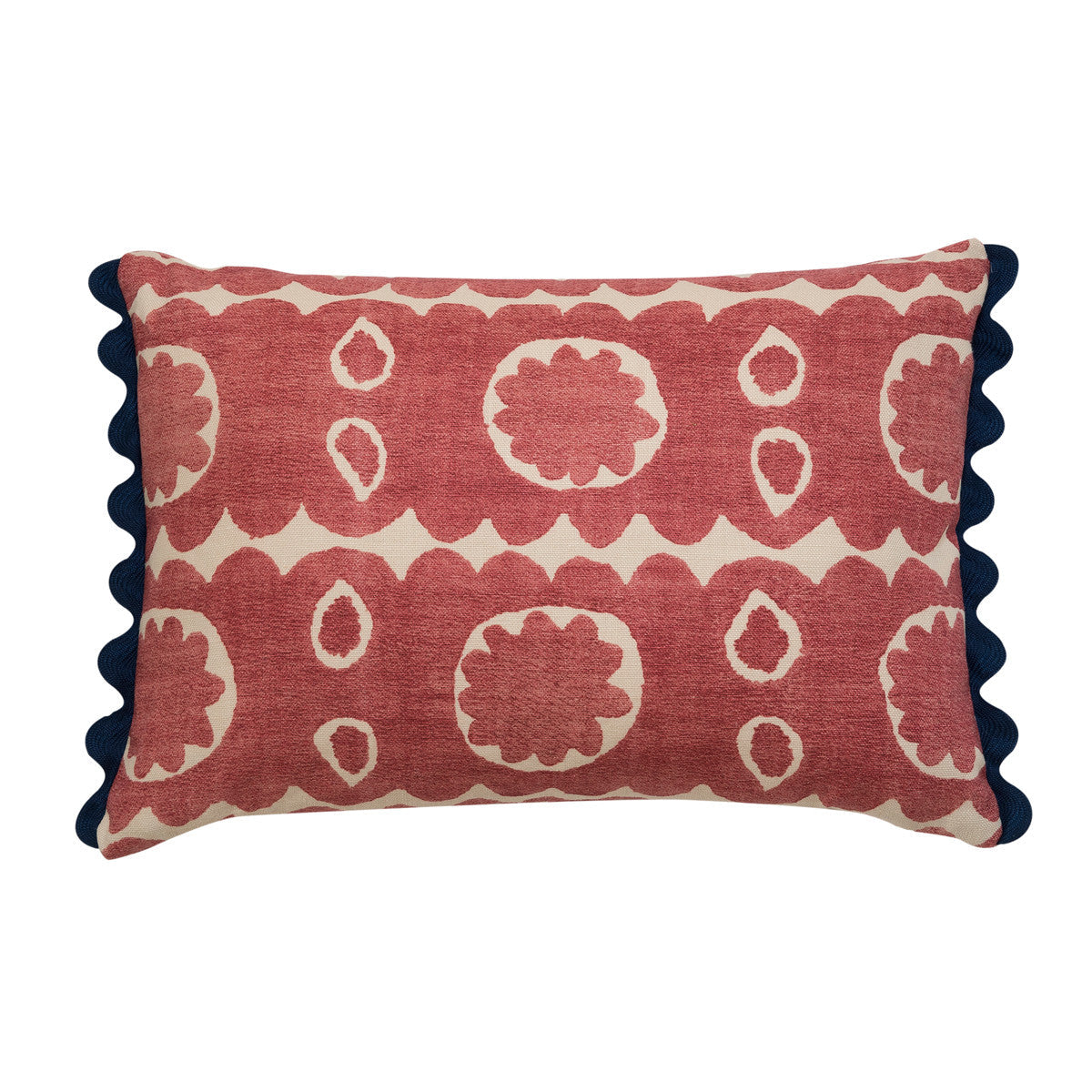 Red floral oblong cushion with navy blue scalloped trim. 