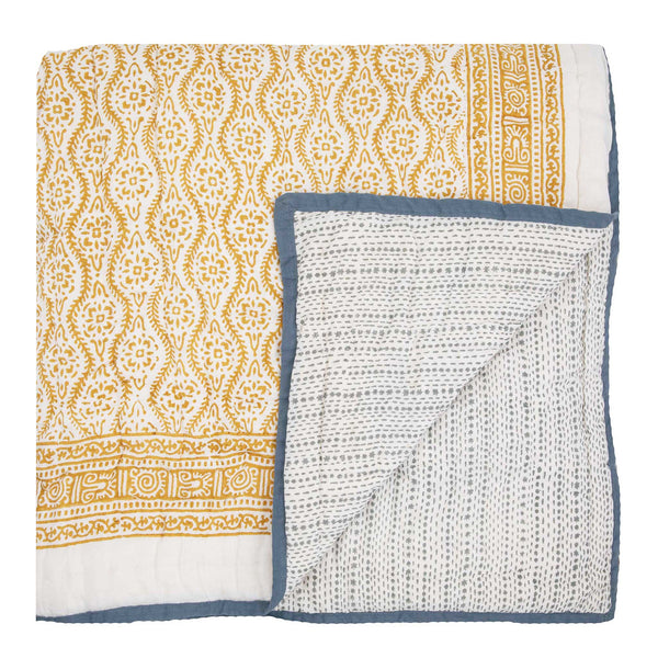 Yellow and blue reversible hand block printed bed quilt with a floral motif from Wicklewood